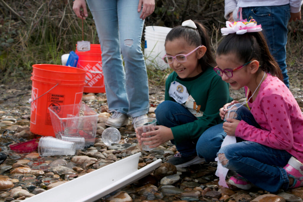 Elementary school students learn about the salmon lifecycle by raising fish from eggs in their classroom and releasing them into the Mokelumne River through an SJCOE program in partnership with the California Department of Fish and Wildlife. Photo credit: San Joaquin County Office of Education